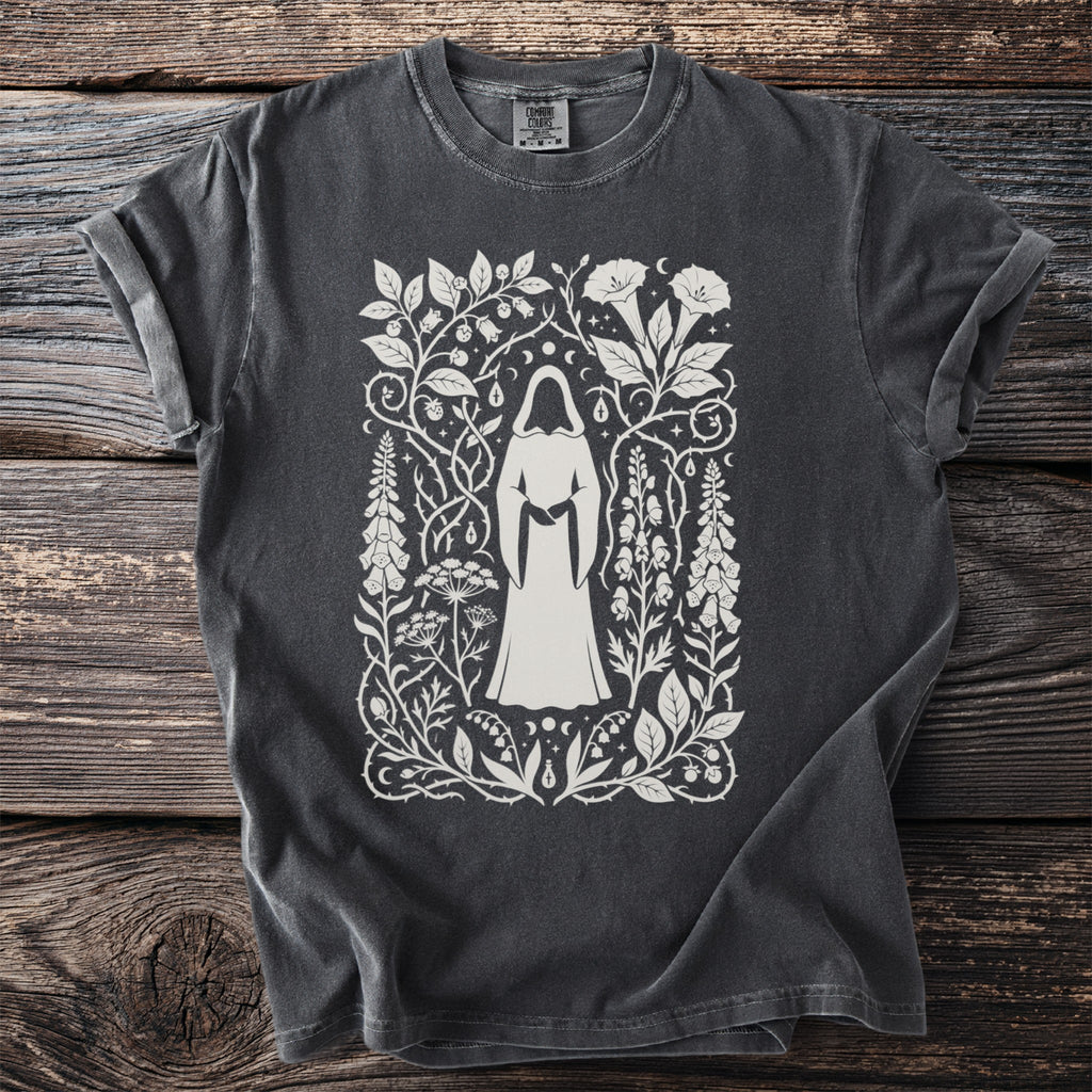 Dark grey t-shirt with a cream-colored occult-inspired botanical print featuring a hooded figure.