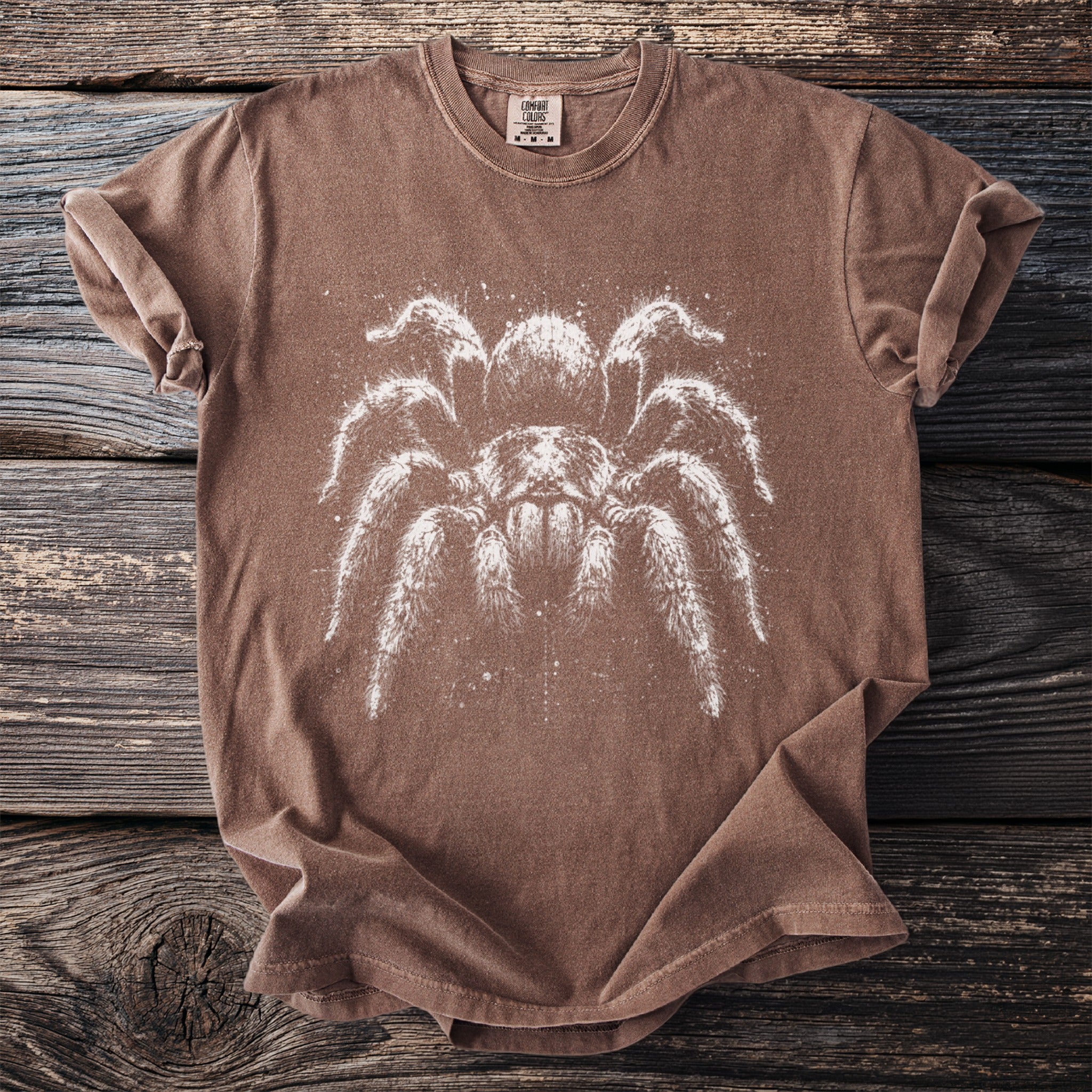 Brown t-shirt with white tarantula graphic and comfort colors tag.