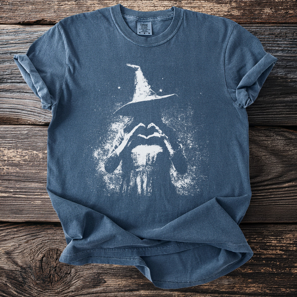 Blue t-shirt with white graphic of a witch forming a heart with her hands.