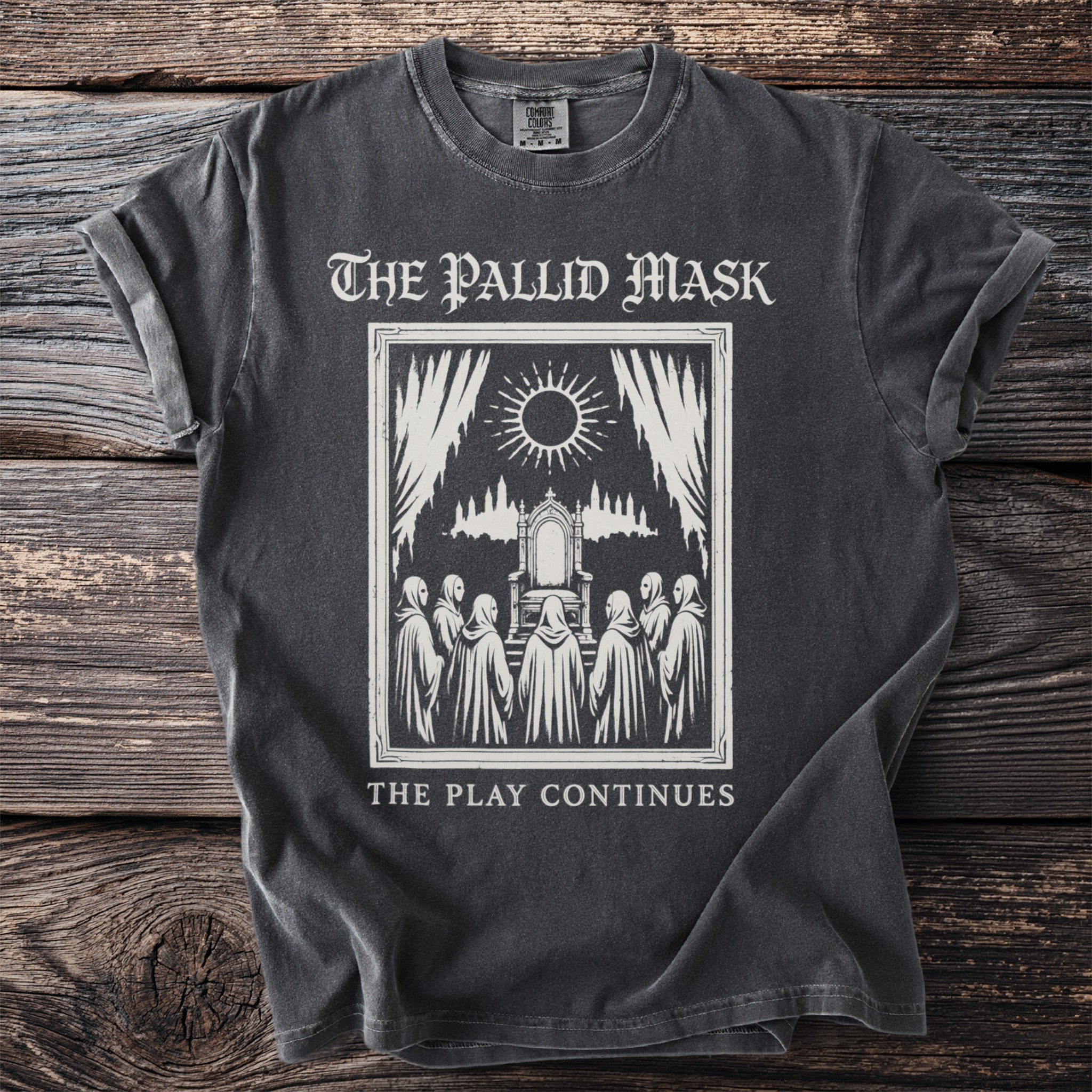 Dark t-shirt with "The Pallid Mask" and "The Play Continues" text and a graphic.