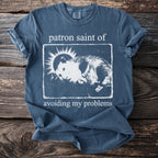 Blue t-shirt with "patron saint of avoiding my problems" and a opossum graphic.