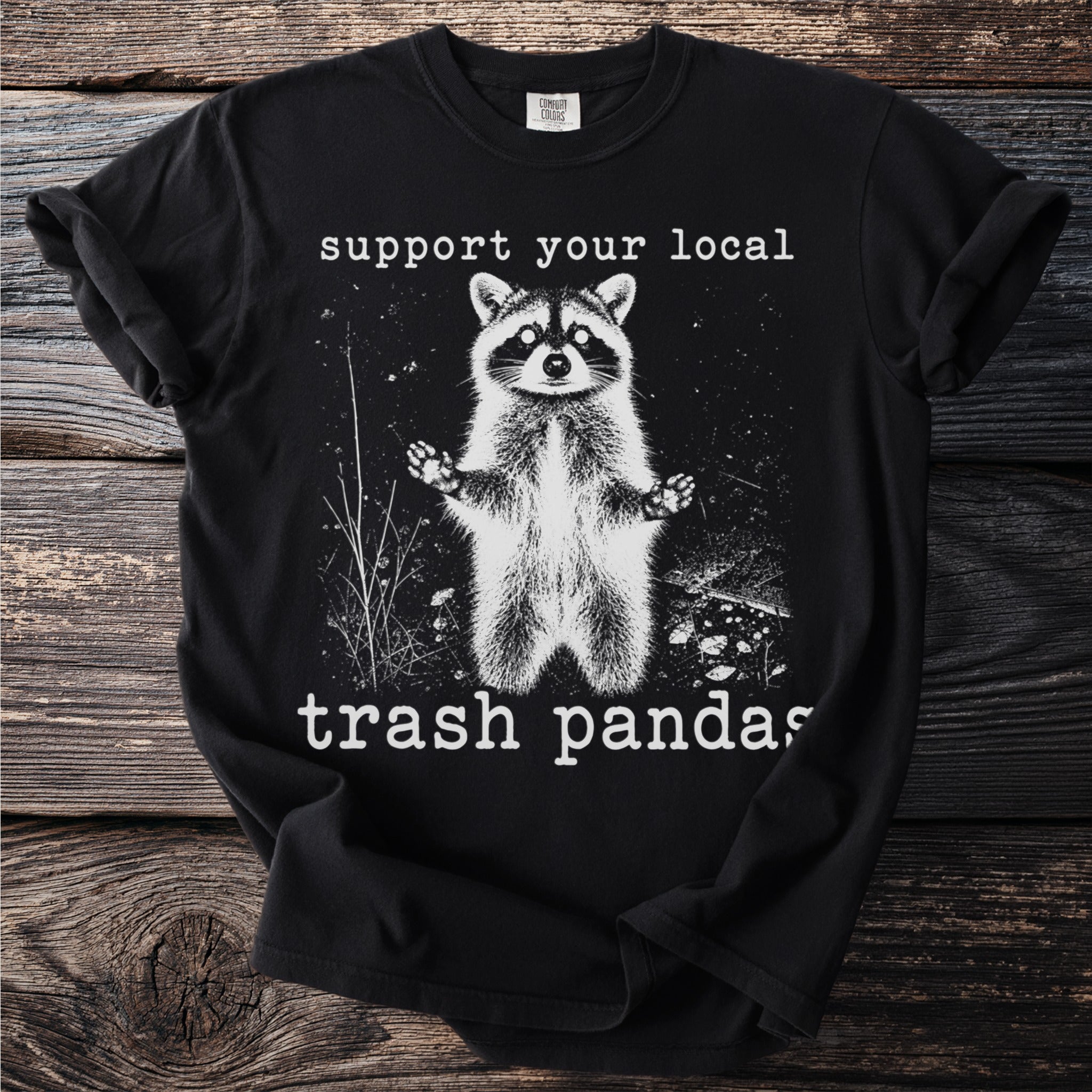 Black t-shirt with raccoon graphic and text "support your local trash pandas".