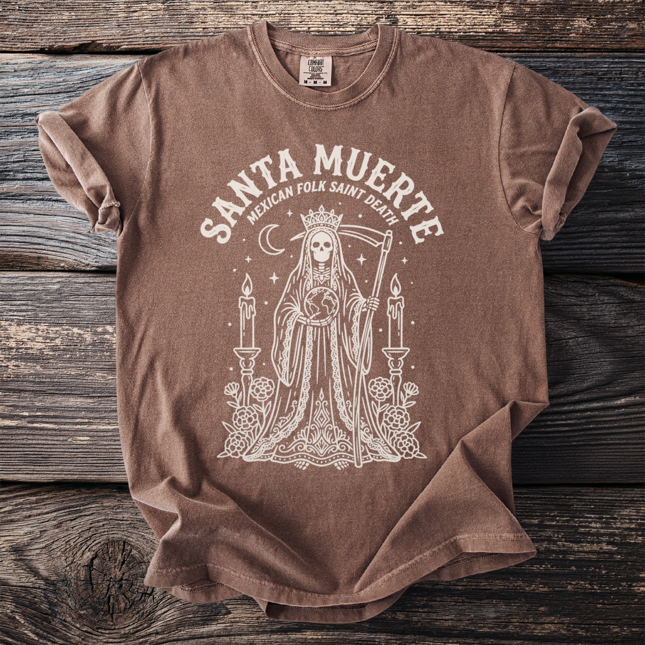 Brown t-shirt with "Santa Muerte Mexican Folk Saint Death" graphic of a robed skeleton holding the Earth.