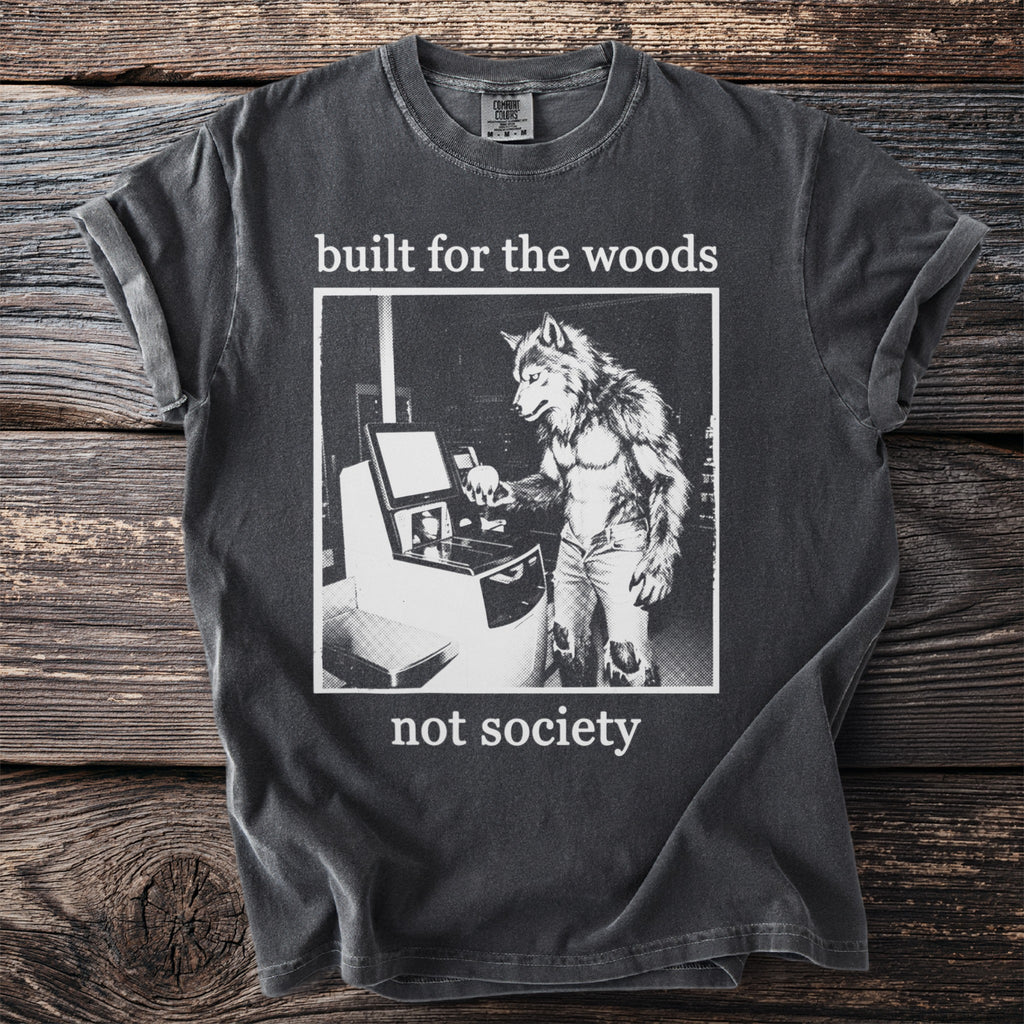 T-shirt with wolf-man at computer and text "built for the woods not society".