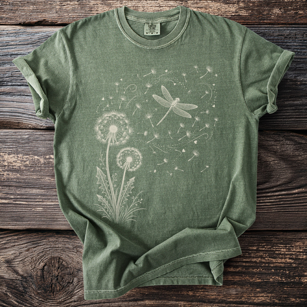 Green t-shirt with a line drawing of dandelions and a dragonfly.