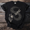 Black t-shirt with a cream-colored graphic of dandelions and a dragonfly.