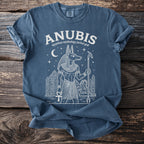 Blue T-shirt with Anubis, Egyptian mythology jackal god, and pyramids graphic.