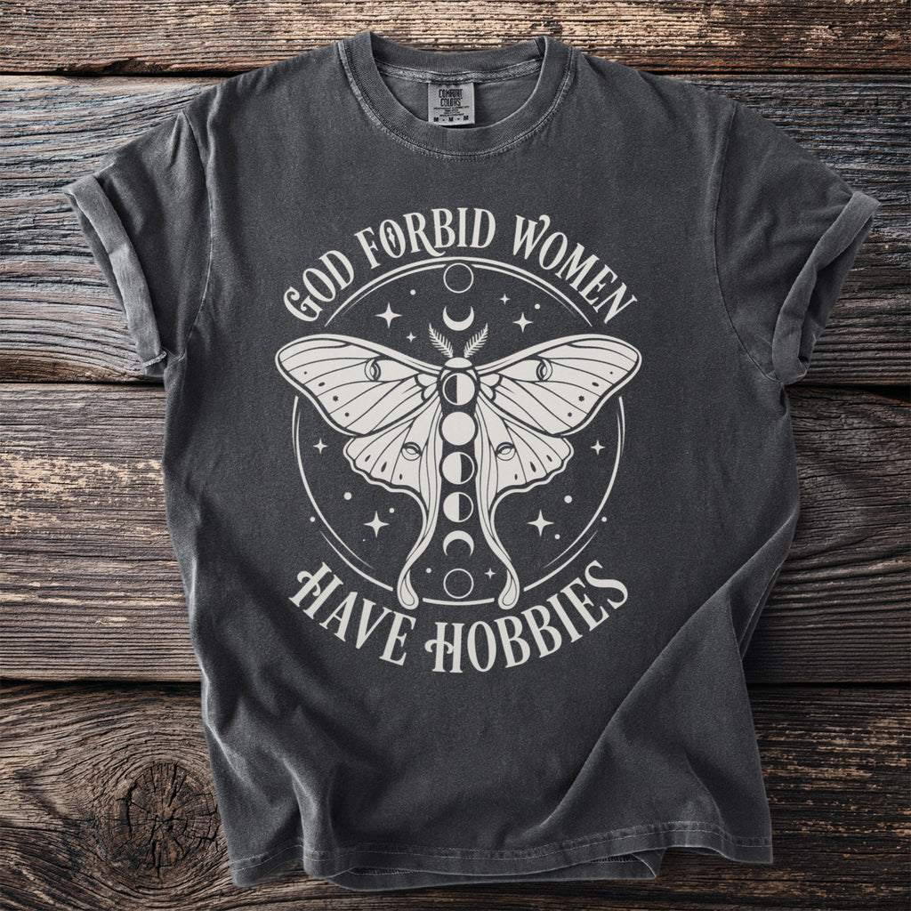 Dark grey t-shirt with white text and graphics of a moth and moon phases.