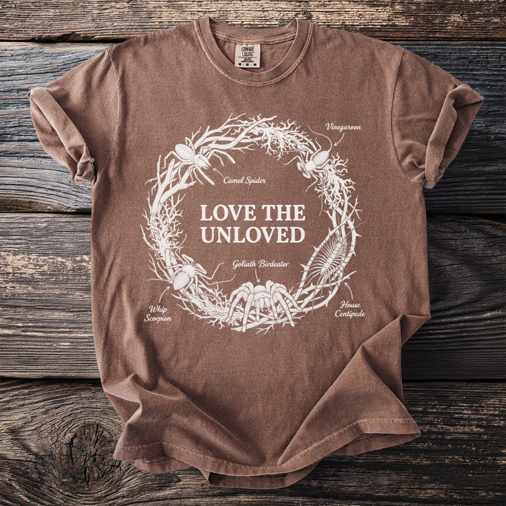 Brown t-shirt with "LOVE THE UNLOVED" and various insects in a circular design.