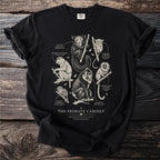 Black t-shirt with "The Primate Cabinet" design featuring scientific illustrations of seven primates.
