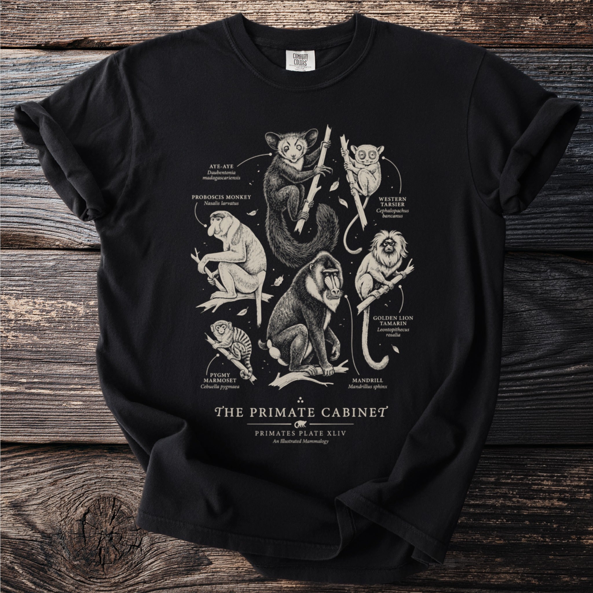 Black t-shirt with "The Primate Cabinet" design featuring scientific illustrations of seven primates.