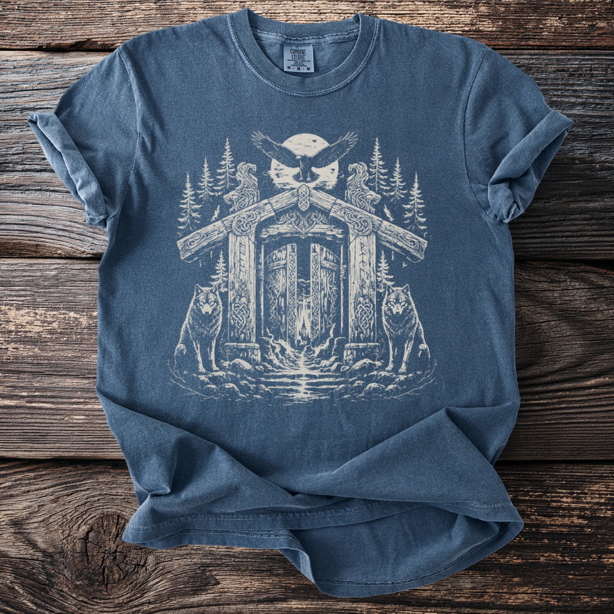 Blue t-shirt with a Nordic-inspired gate, wolves, and eagle graphic.