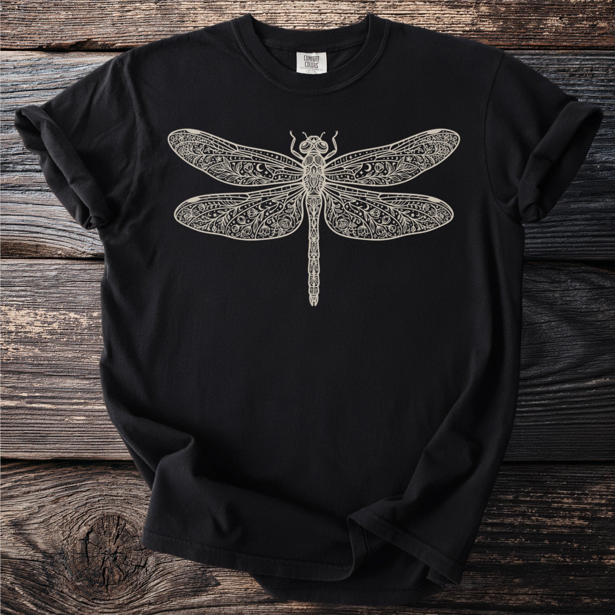 Black t-shirt with a detailed cream-colored dragonfly graphic.
