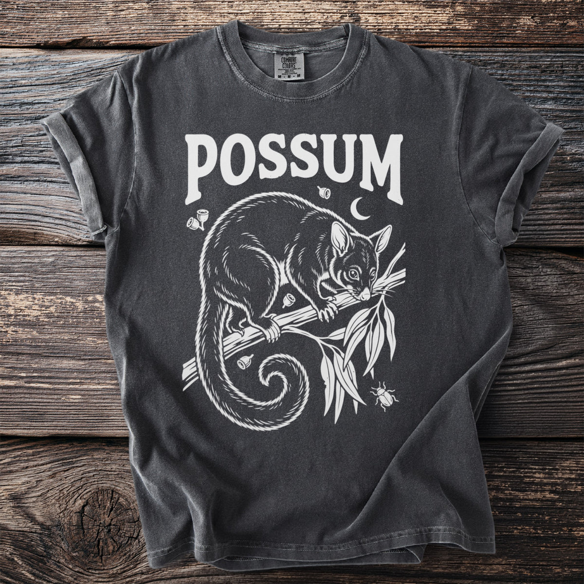 Dark grey t-shirt with white graphic of a possum on a branch, text "POSSUM".