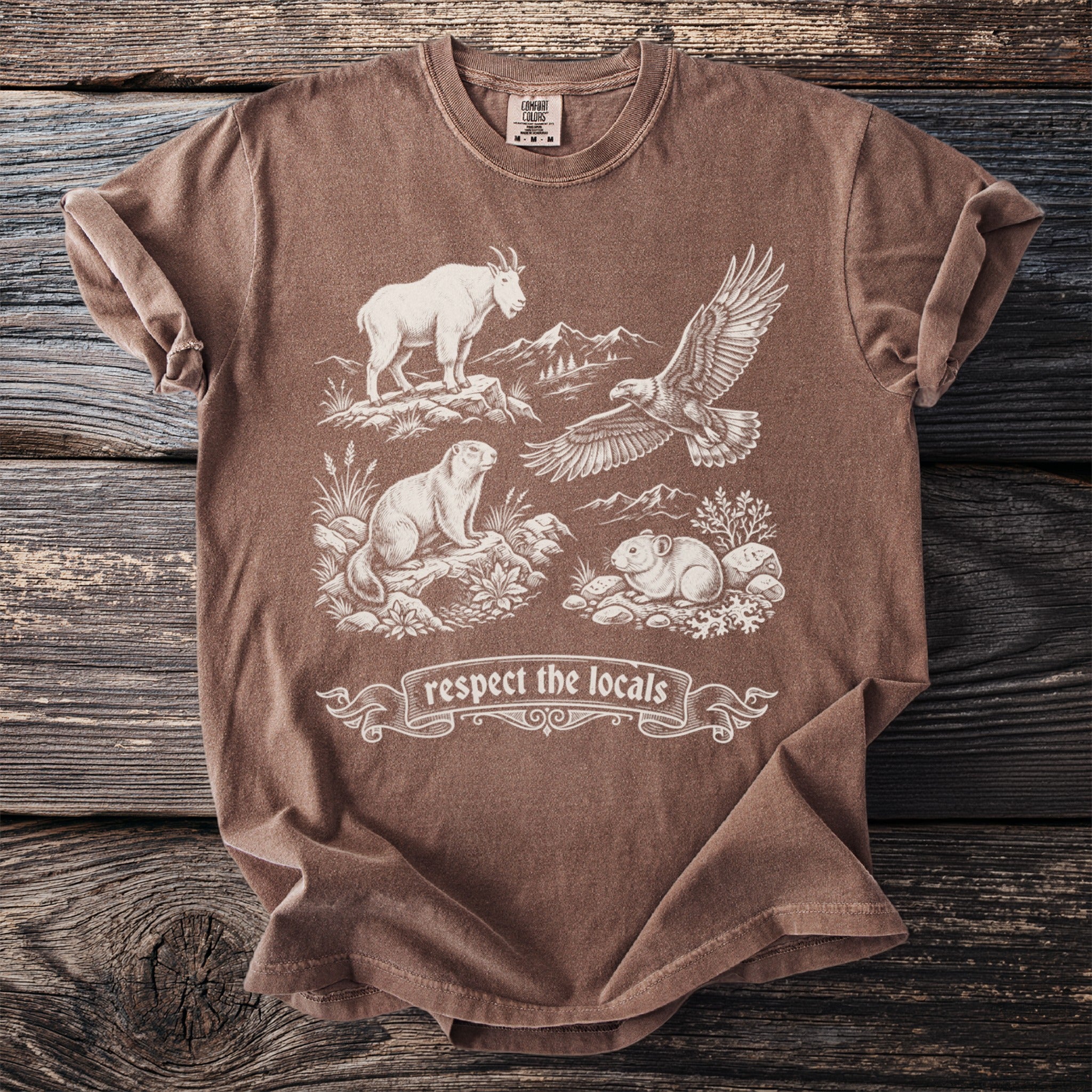 Brown t-shirt with white wildlife illustration and "respect the locals" text.