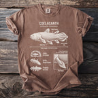 Faded brown t-shirt with a white line drawing of a coelacanth and its anatomical features.