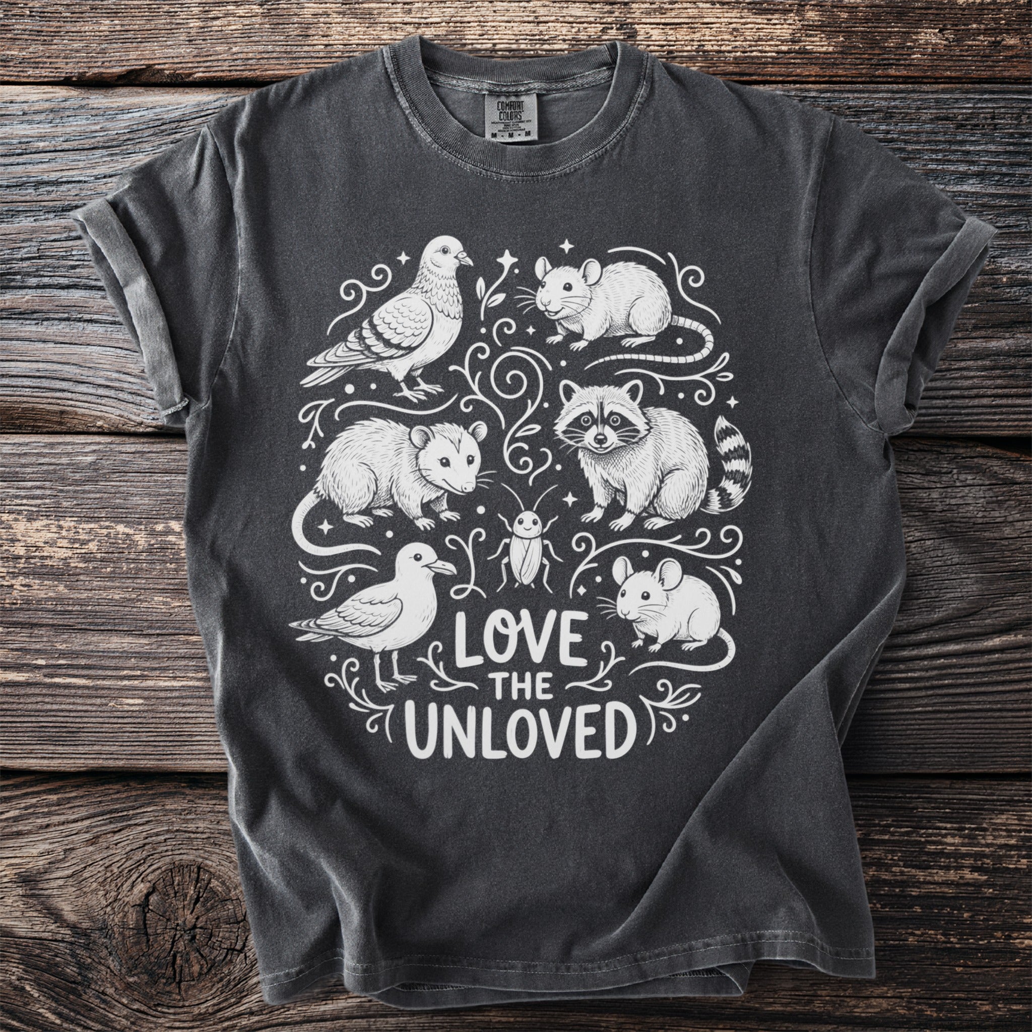 Dark gray t-shirt with white illustration of animals and text "LOVE THE UNLOVED".