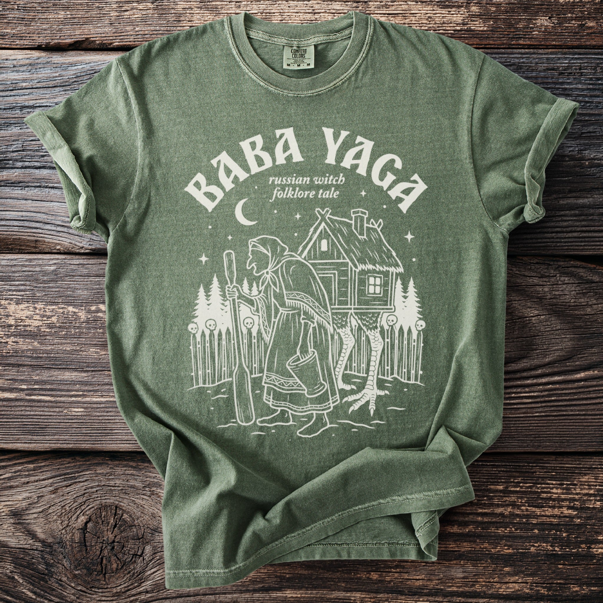 Green t-shirt with "BABA YAGA russian witch folklore tale" and illustration.