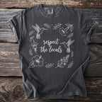 Dark grey t-shirt with white line art of hummingbirds, flowers, and text that reads "respect the locals."