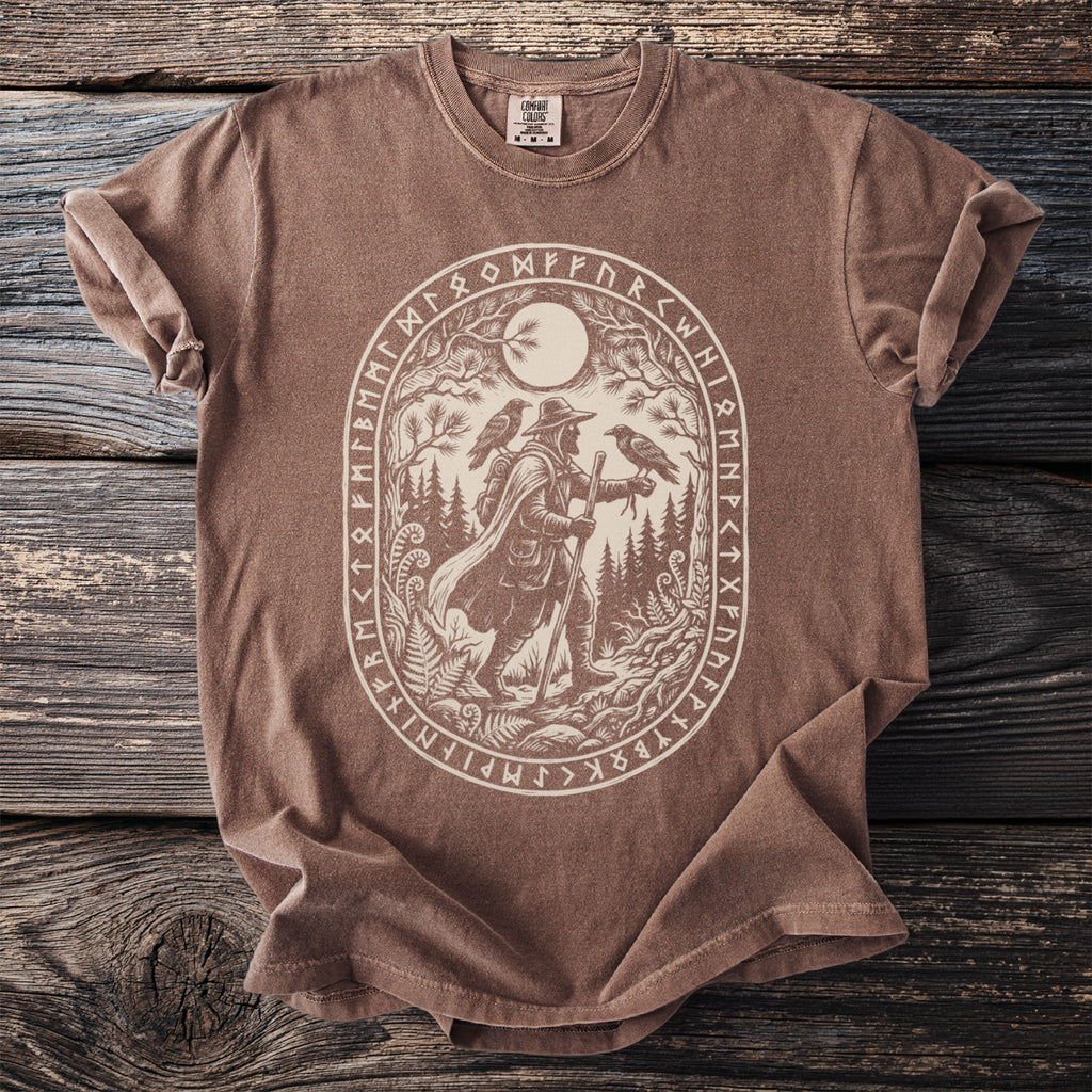 Brown t-shirt with oval rune border around traveler with two ravens.