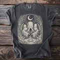 Dark gray t-shirt with cream graphic of hooded figures around a campfire under a crescent moon.