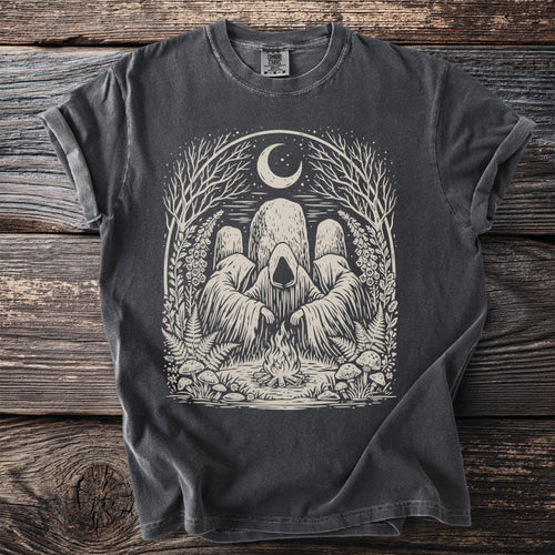 Dark gray t-shirt with cream graphic of hooded figures around a campfire under a crescent moon.