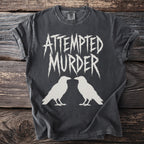 Dark grey t-shirt with "ATTEMPTED MURDER" text and two white crows.