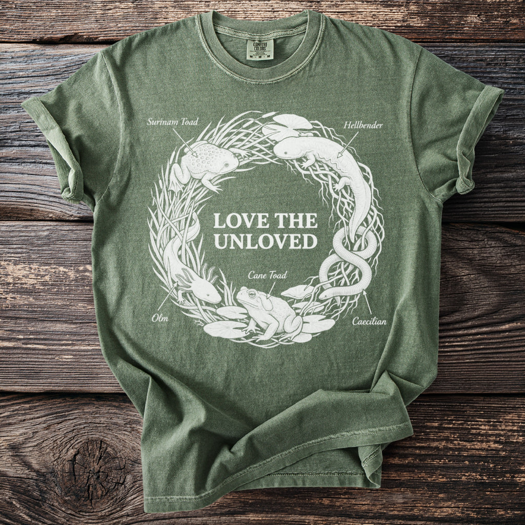 Green t-shirt with white circular graphic of amphibians and text "LOVE THE UNLOVED."