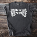 Dark grey t-shirt with white gothic text "Merry Creepmas" and poinsettias.