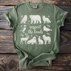 Green t-shirt with line drawing of arctic animals and "respect the locals" text.