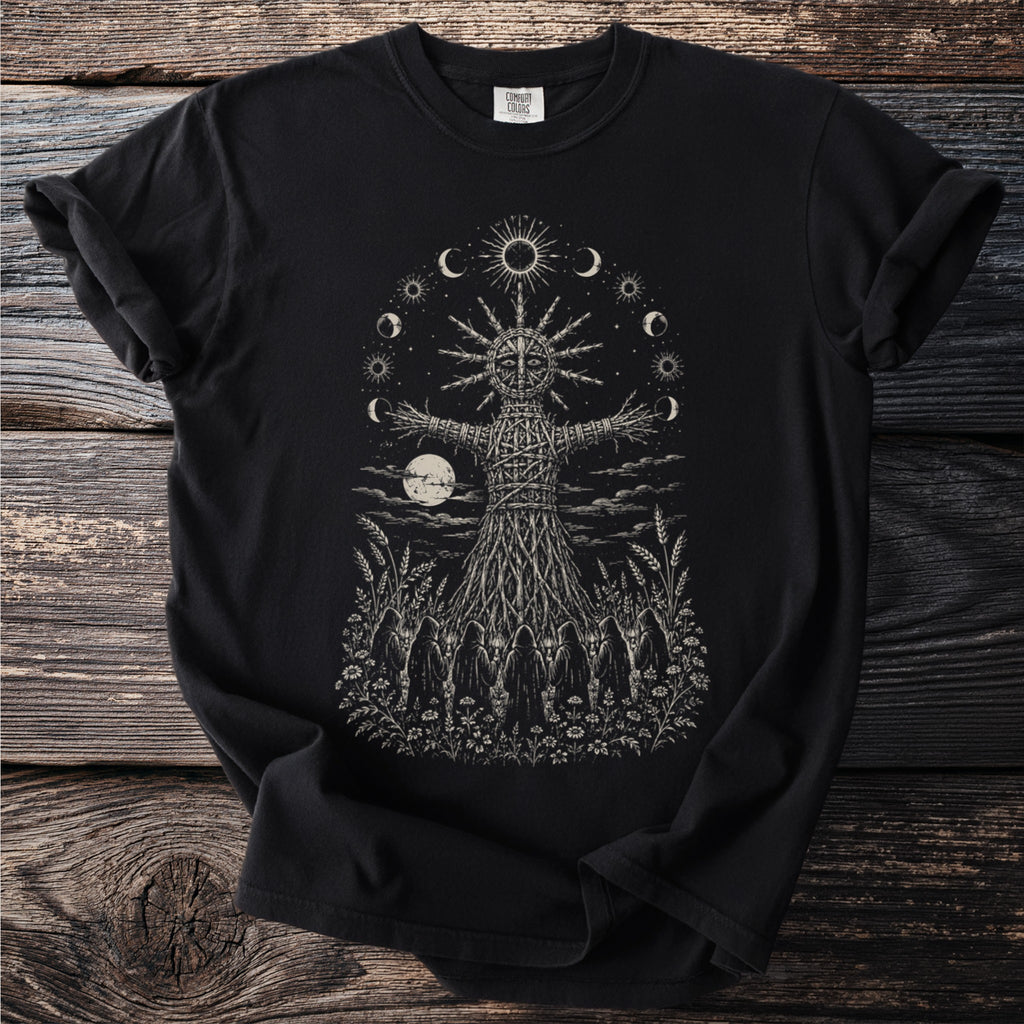 Black t-shirt with a sketch of a wicker figure surrounded by moons, sun, and hooded figures.