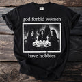 Black t-shirt with graphic: "god forbid women have hobbies" and Ouija board scene.