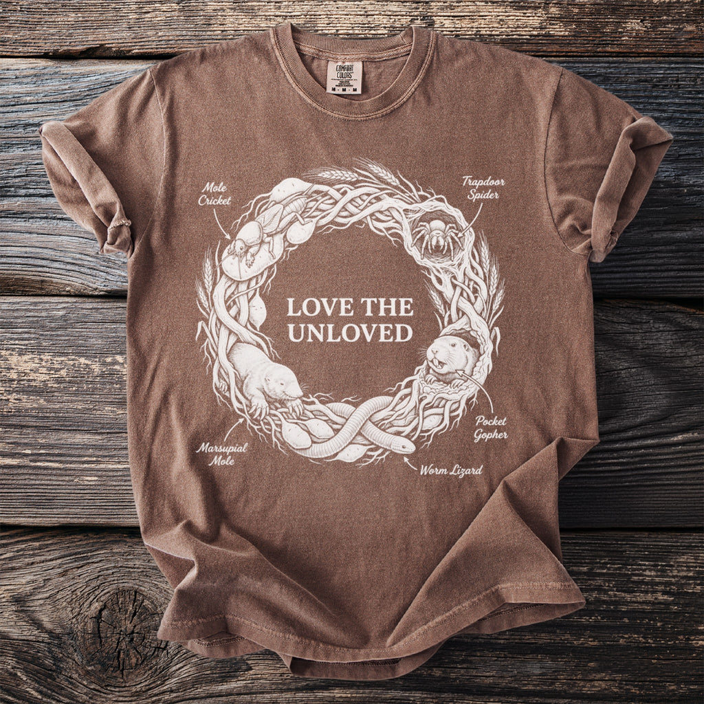 Brown t-shirt with white graphic of "LOVE THE UNLOVED" and various creatures in a circular design.