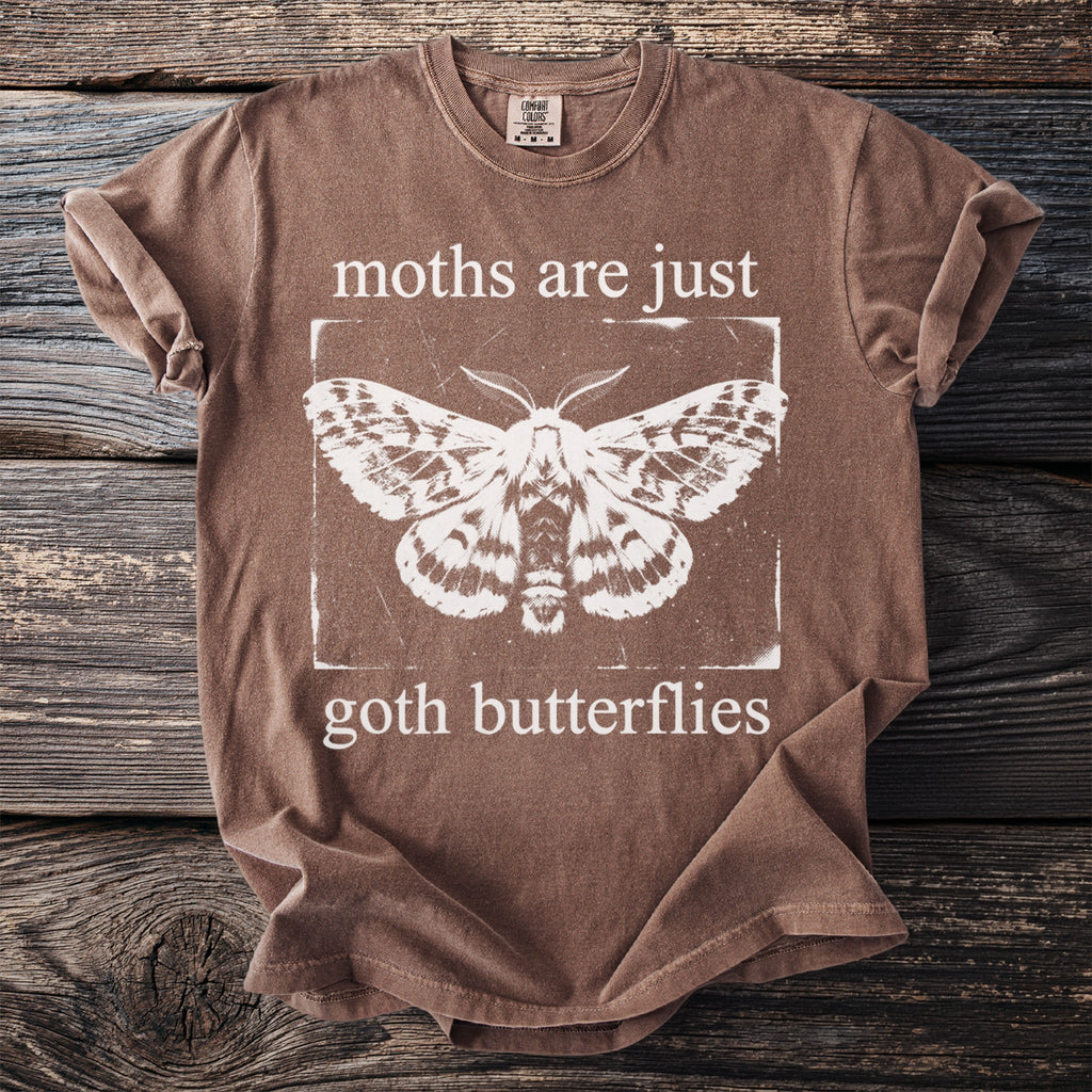 Brown t-shirt with white moth graphic and text "moths are just goth butterflies".