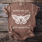 Brown t-shirt with white moth graphic and text "moths are just goth butterflies".