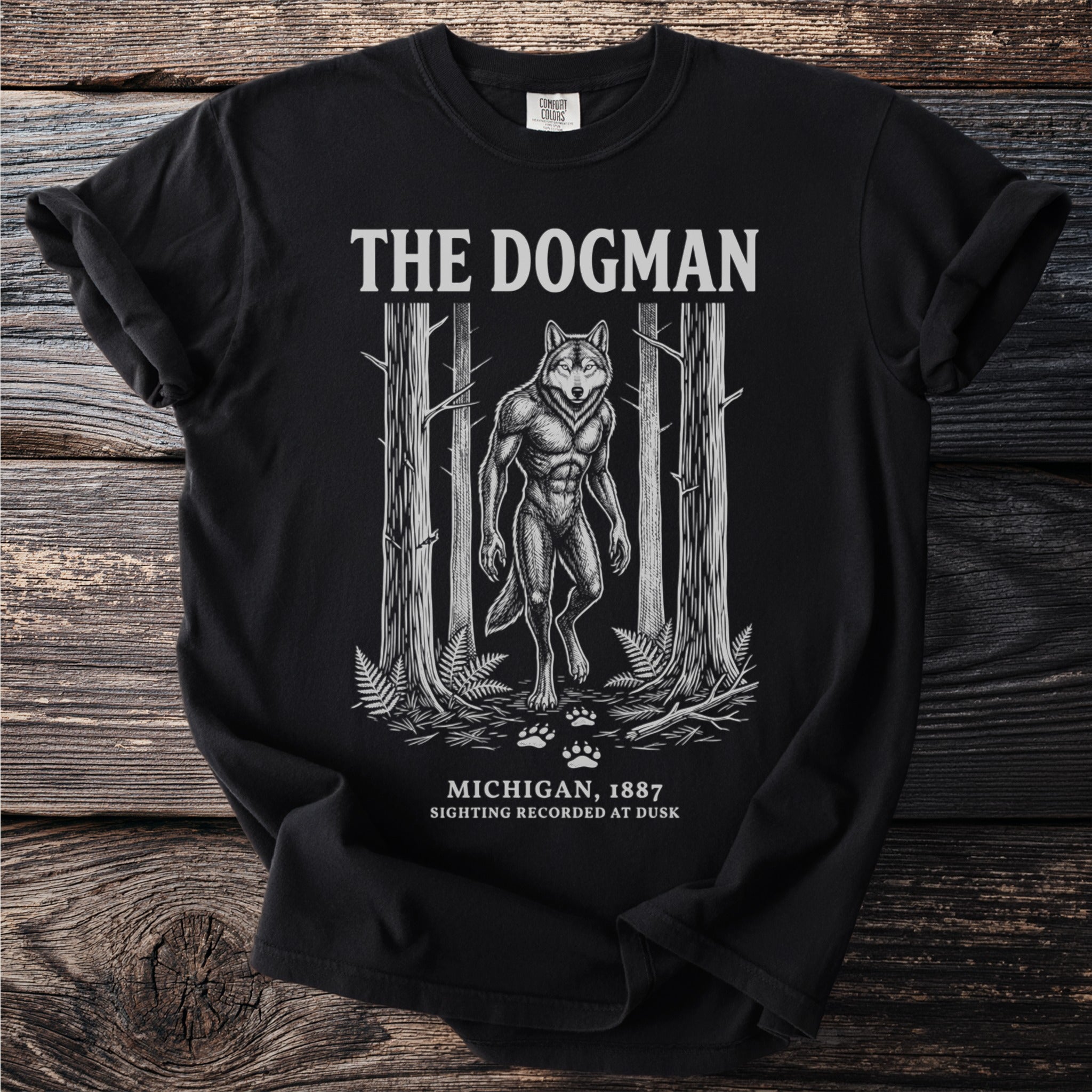 Black t-shirt featuring "The Dogman" text with a werewolf in a forest.