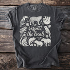 T-shirt with "respect the locals" text and illustrations of rainforest animals.