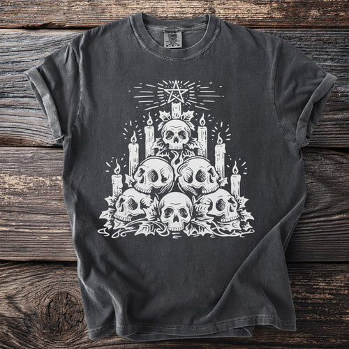 Dark t-shirt with white skull pile, candles, and pentagram graphic.