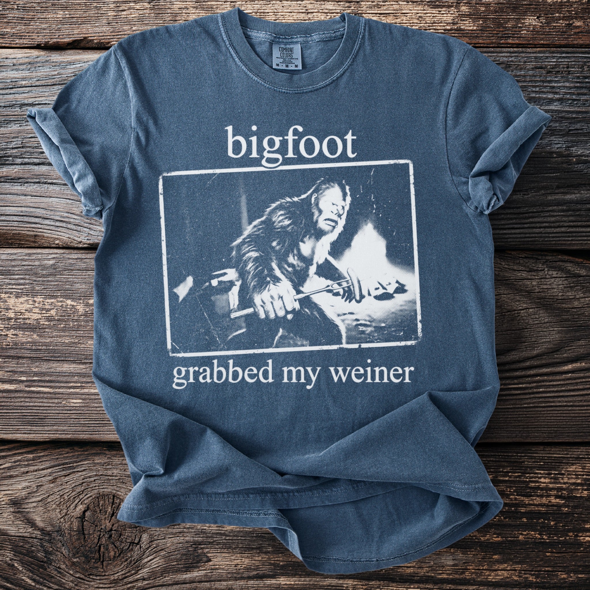 Blue t-shirt with "bigfoot grabbed my weiner" text and Bigfoot graphic.