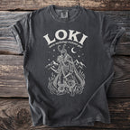 Dark grey t-shirt with white graphic of Loki, mountains and snakes.