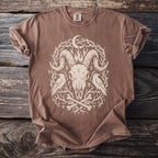 Brown Comfort Colors t-shirt with a cream ram skull, moon, crows, and runes design.