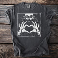 Dark charcoal t-shirt with graphic of a vampire making a heart shape with its hands.