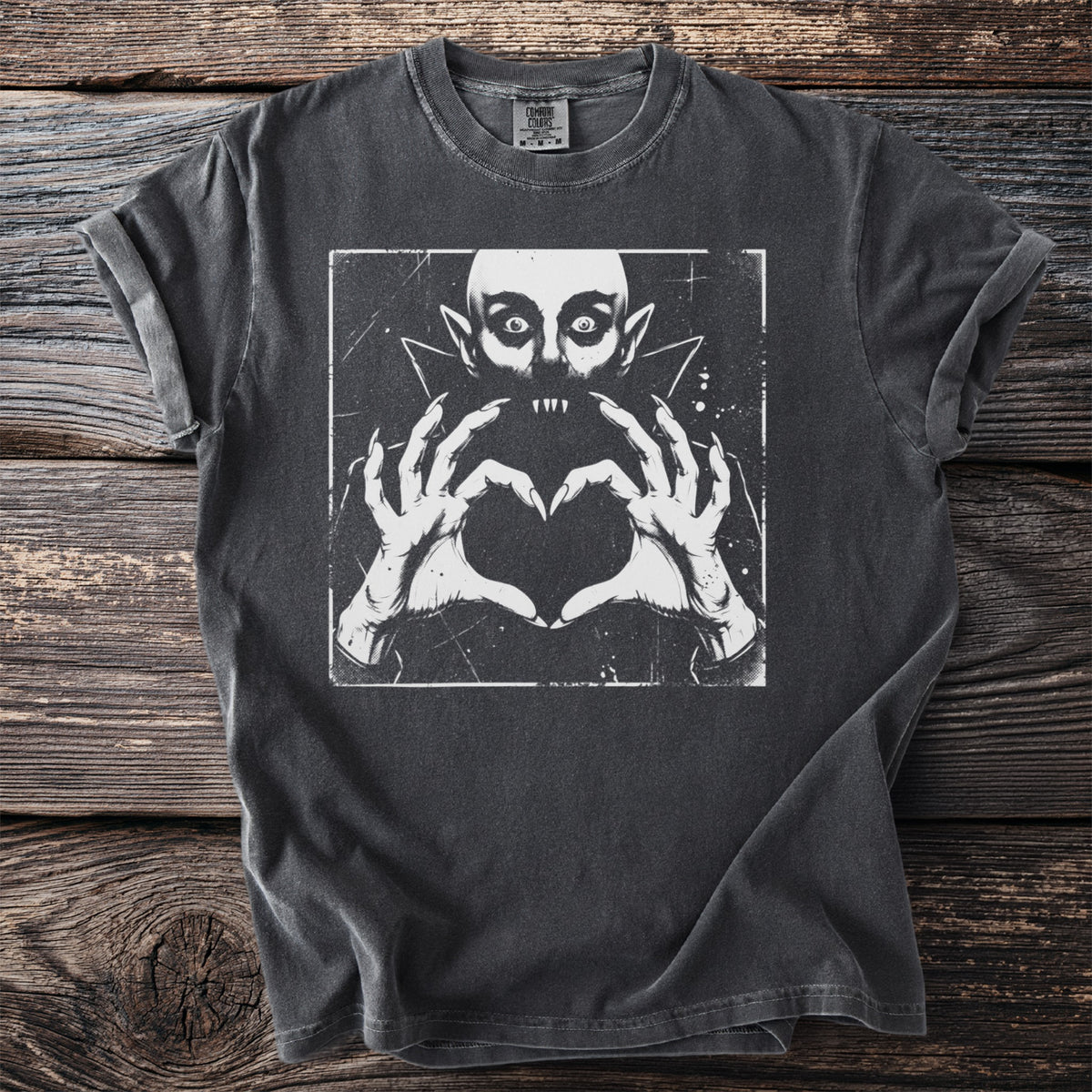Dark charcoal t-shirt with graphic of a vampire making a heart shape with its hands.