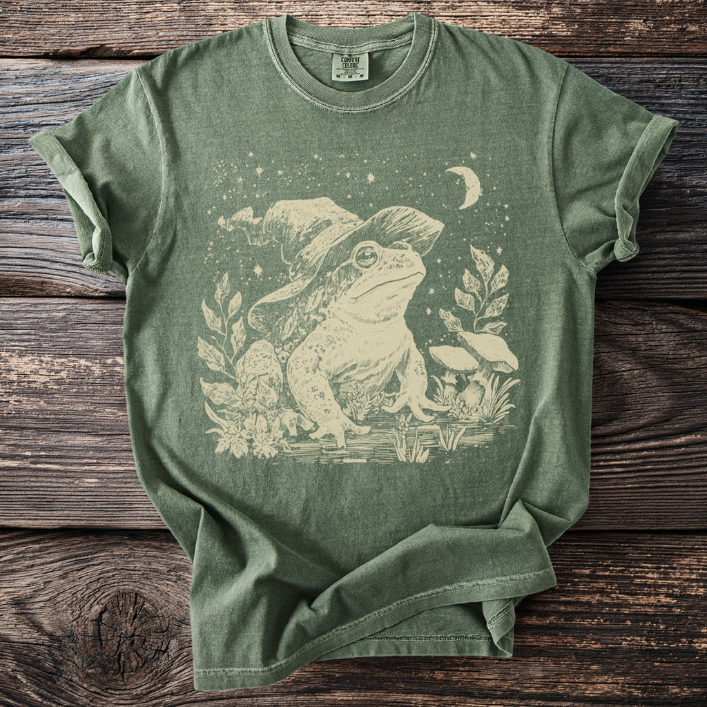 Green t-shirt with vintage frog wearing a witch hat and crescent moon graphic.