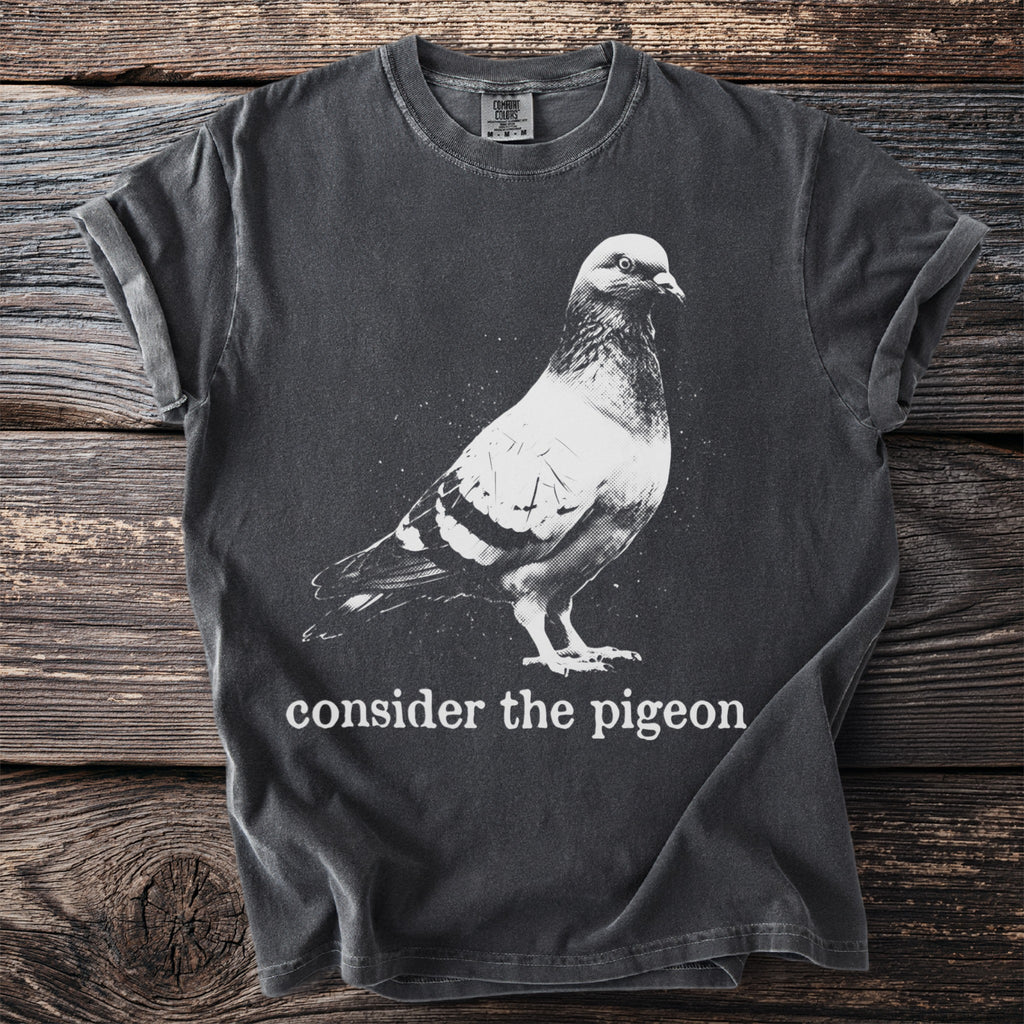 Dark grey t-shirt with "consider the pigeon" text and a pigeon graphic.