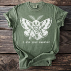 Green t-shirt with a distressed white moth graphic and text: "i ate your sweater."