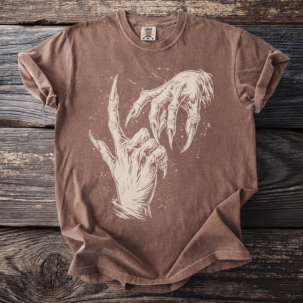 Brown t-shirt with a graphic of two clawed, skeletal hands reaching for each other.