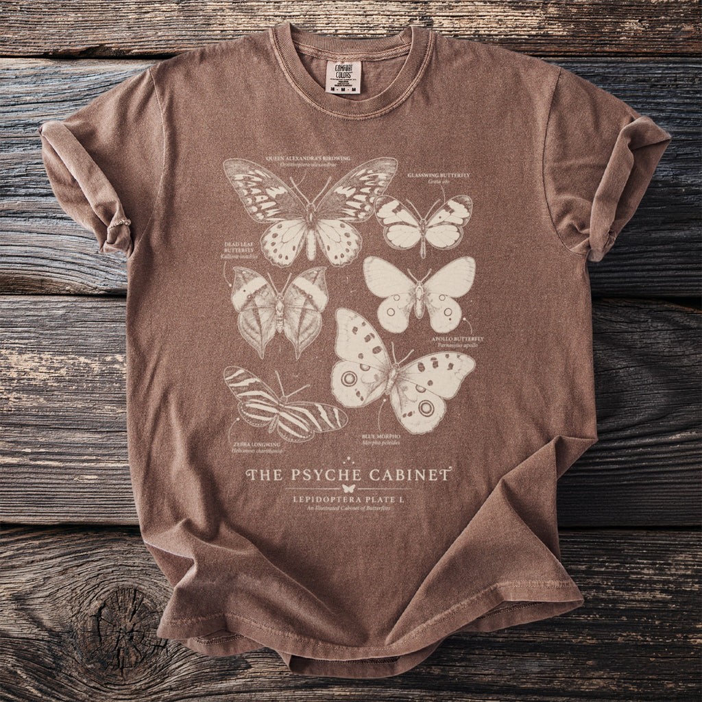 Brown t-shirt with "The Psyche Cabinet" and illustrations of various butterflies.