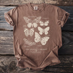 Brown t-shirt with "The Psyche Cabinet" and illustrations of various butterflies.