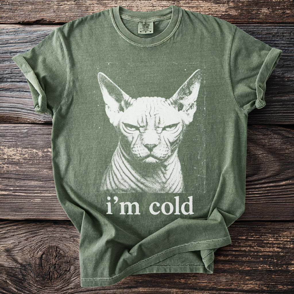 Green t-shirt with a grumpy Sphynx cat graphic and "i'm cold" text.
